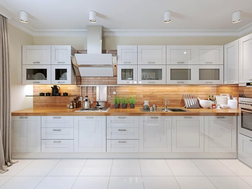 Contemporary kitchen design with white cabinets, shiplap backsplash and cookware