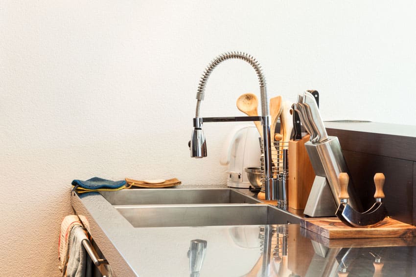 Countertop with kitchenware, sink, and kitchen faucet