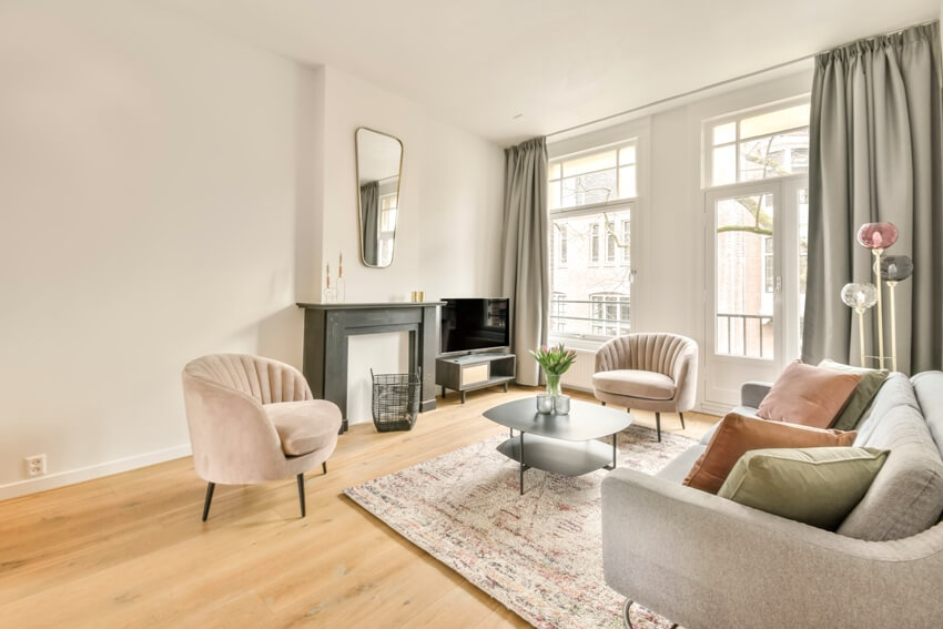 Luxury vinyl plank flooring and a loveseat with several accent pillows