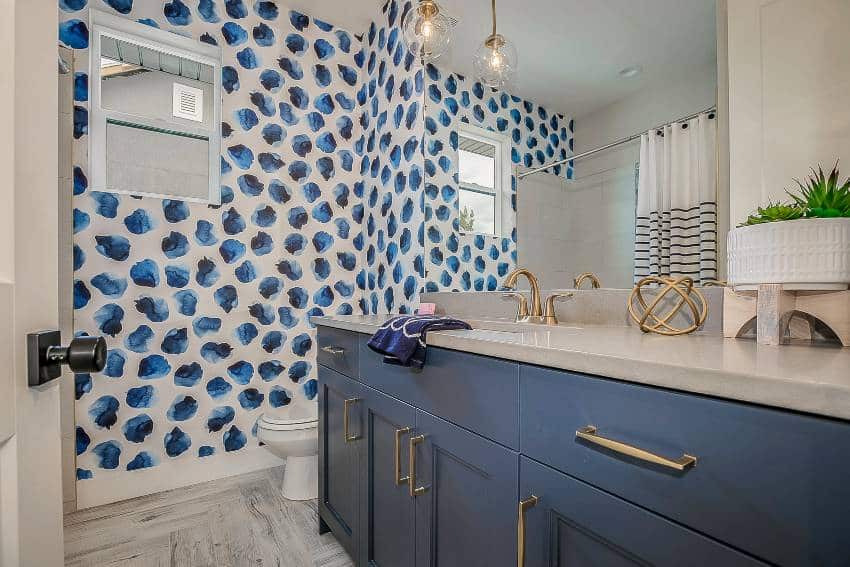 Cute bathroom with blue wall accents and cabinets