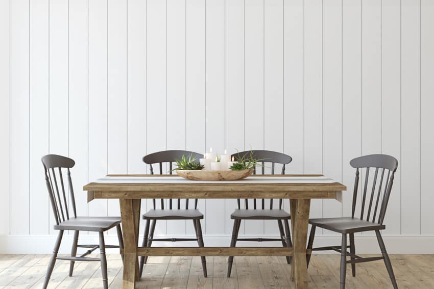 Dining room with board and batten wall wood, table, and chairs