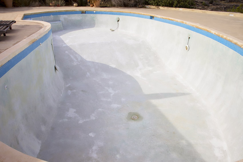 Empty swimming pool with concrete roll-on plaster