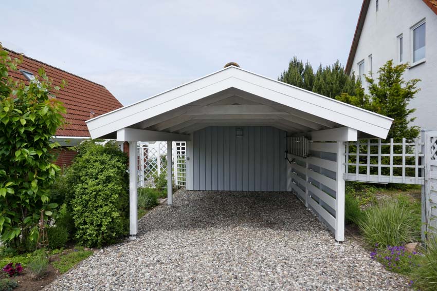 Freestanding type of carport with gravel driveway