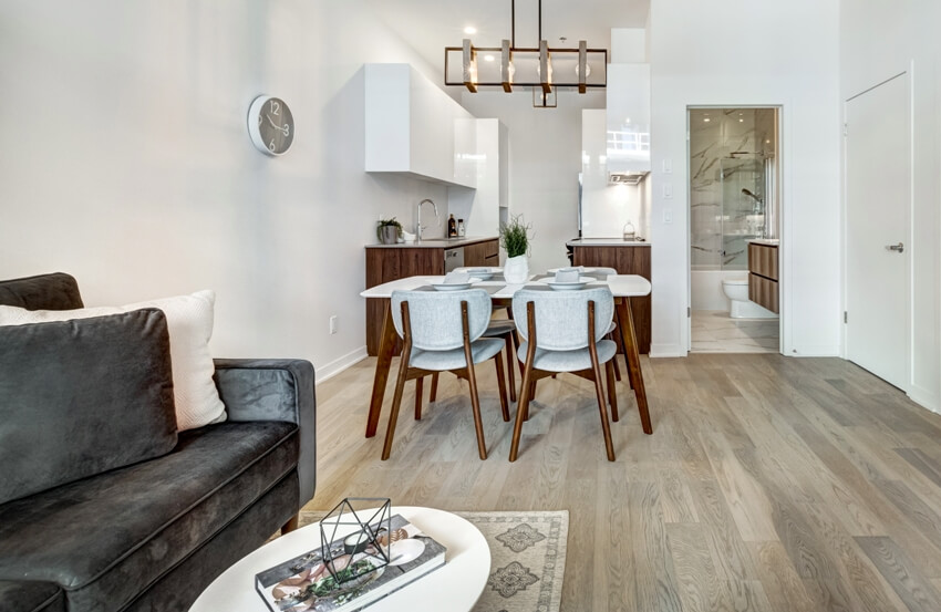 Open layout room with dining set and grey loveseat