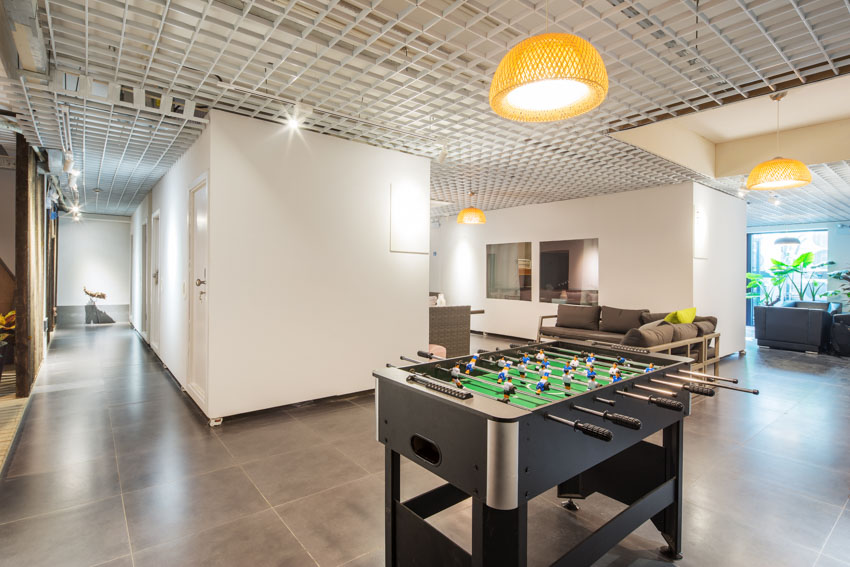 Game room with tile floor, foosball table, and hanging light
