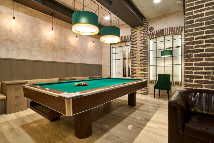 Game room with laminate floor, pool table, hanging lights, windows, and chair