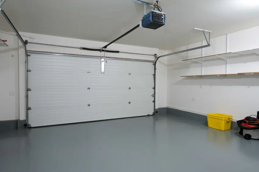 Garage with epoxy floor, retractable door and shelves
