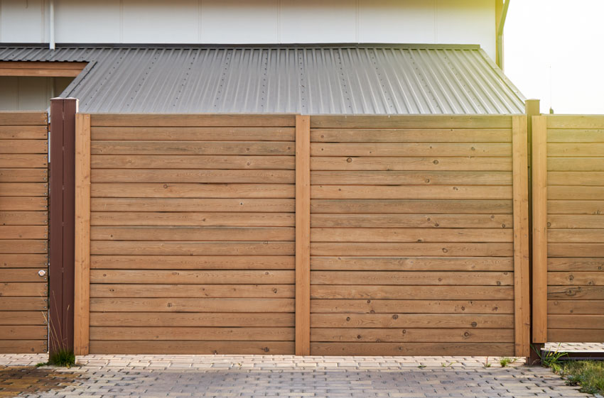 Horizontal planked gate with concrete pavers