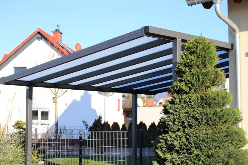 House carport with plexiglass roof, and metal frame