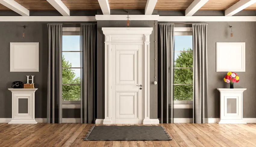 House entranceway with side door side panel curtains, wood floor, wood beam, ceiling, and mat