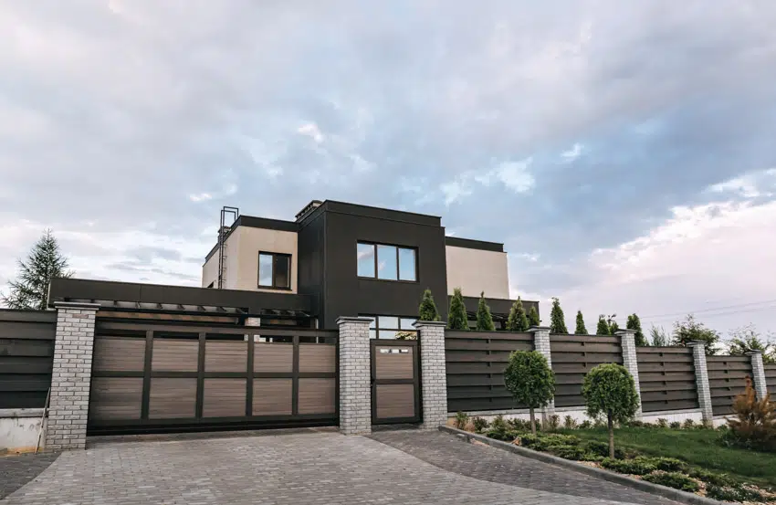 House with flat roof, windows, lawn, and small trees