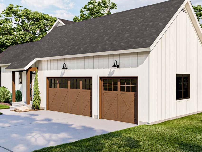 House with drive through garage, siding, pitched roof, driveway, and garage doors