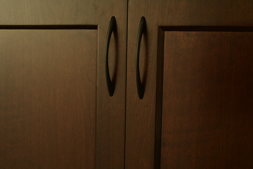 Kitchen cabinet door made of cherry wood with handle