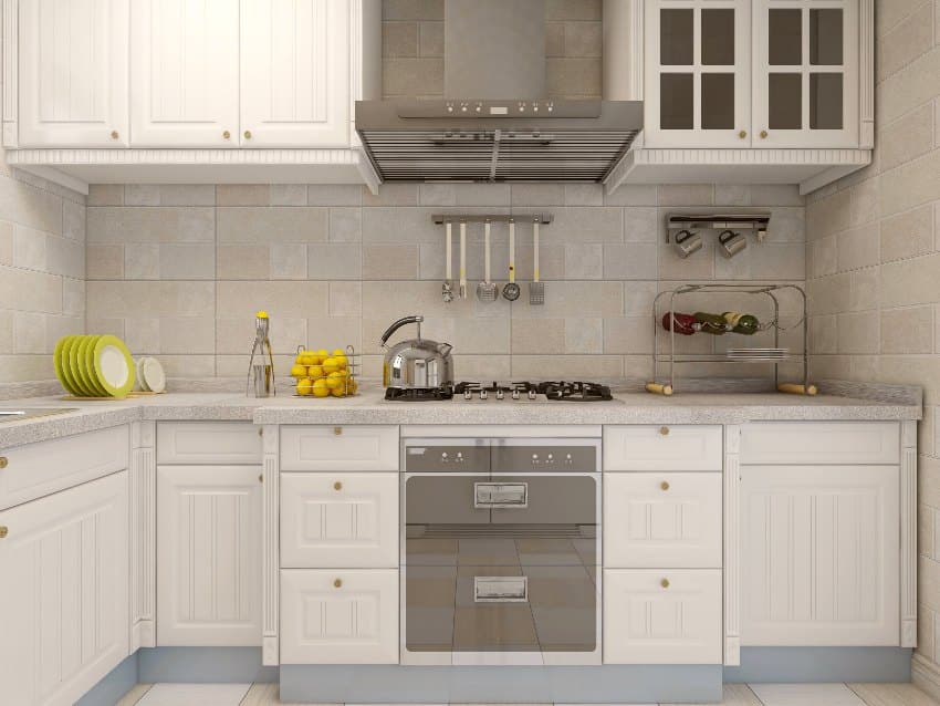 Kitchen interior with white tile backsplash, kitchenware with refrigerator and grooved kitchen cabinets