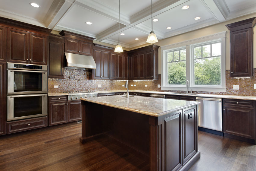 Kitchen with center island, countertops, backsplash, windows, pendant lights, range hood, and solid mahogany wood cabinets