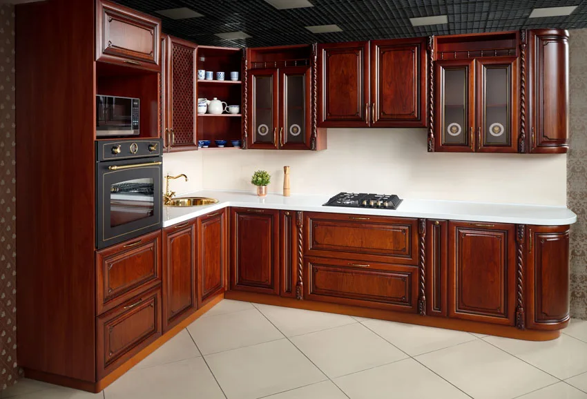Kitchen with dark Bombay mahogany material, ceramic floors, stove, and oven