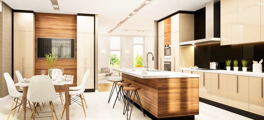 Kitchen with island, countertops, backsplash, dining area, table, chairs, stools, and island faucet