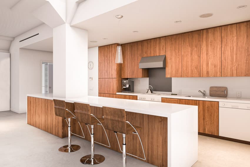 Kitchen with natural walnut cabinets, bar area, high chairs, range hood, backsplash, and ceiling lights