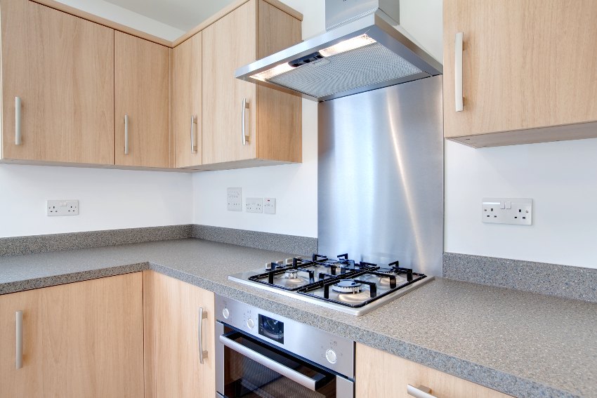 Kitchen with stainless steel appliances, granite countertop and smooth doors