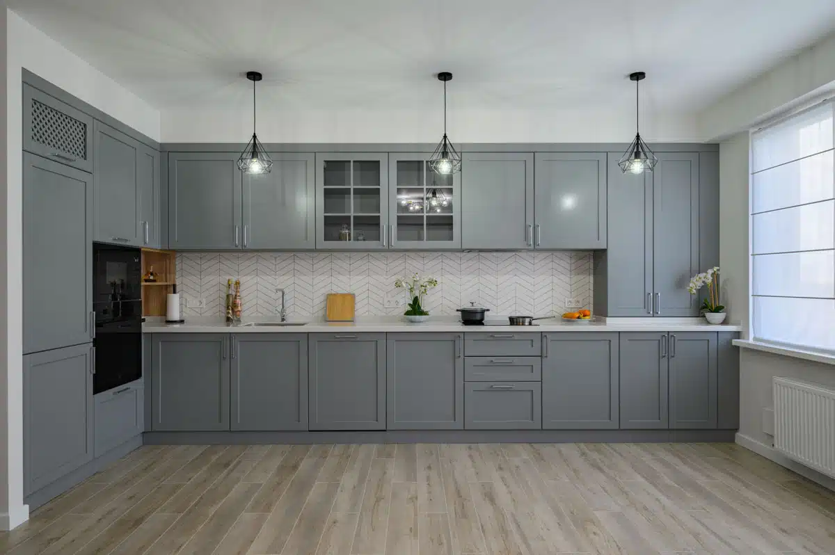 laminate flooring in kitchen with gray cupboards