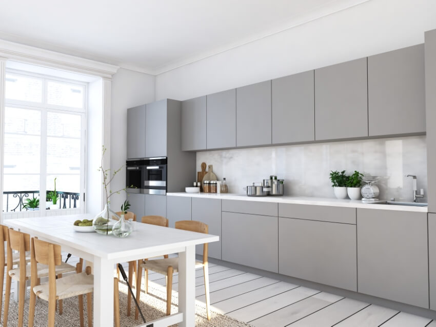 Kitchen with marble backsplash, grey euro style cabinets and wooden dining set