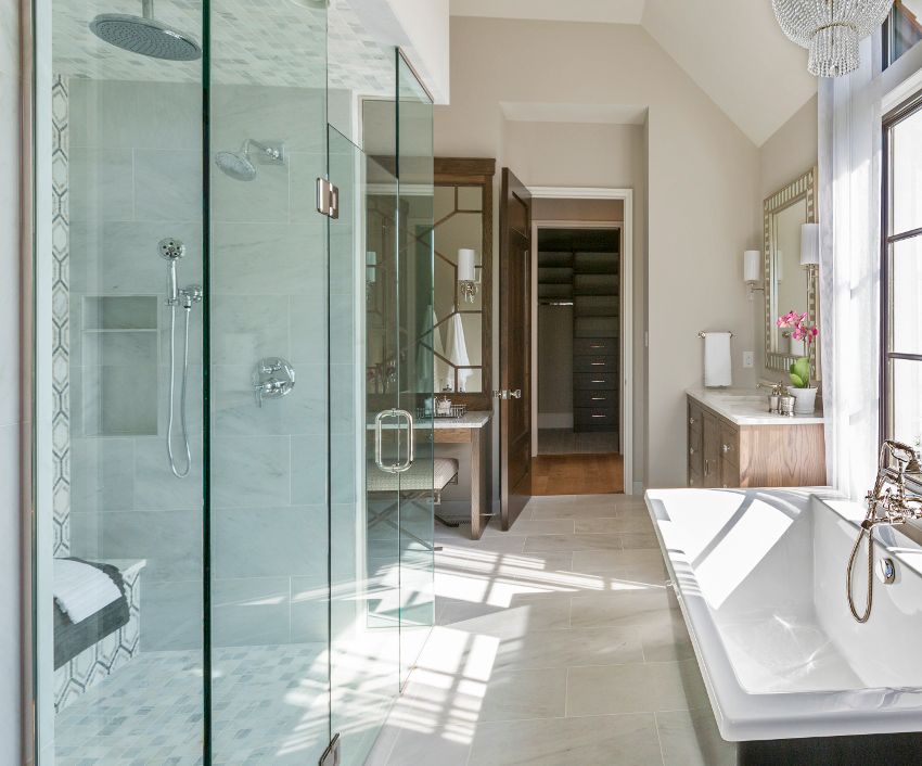 A luxury bathroom with two toned bathtub, tiled floors and shower with tile on the ceiling