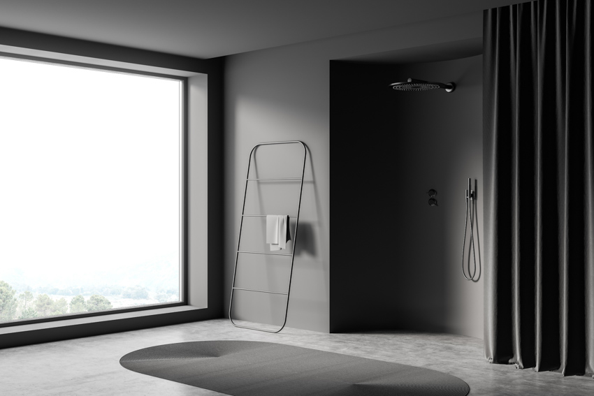 Minimalist bathroom with heavy duty shower curtain, shower head, rug, and window