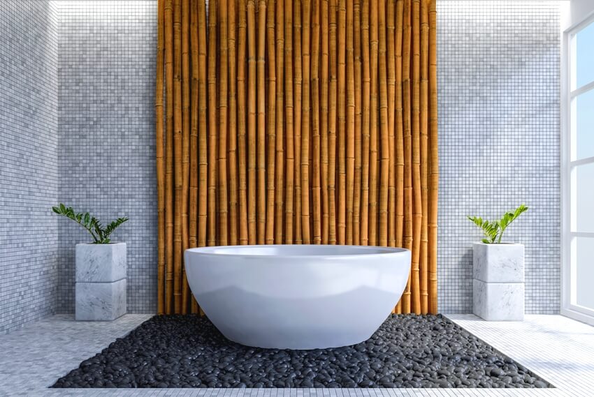 Modern bathroom interior with bamboo accent wall and pebble stones on the floor