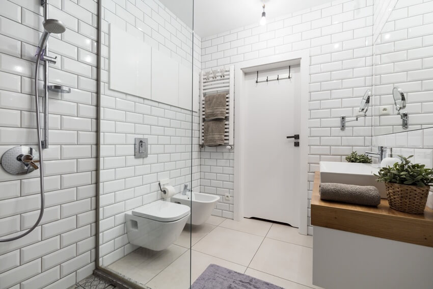 Modern bathroom with subway tiles on wall shower and other bathroom fixtures