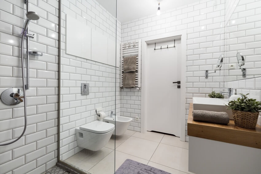 Bathroom with subway tiles on wall shower and other fixtures