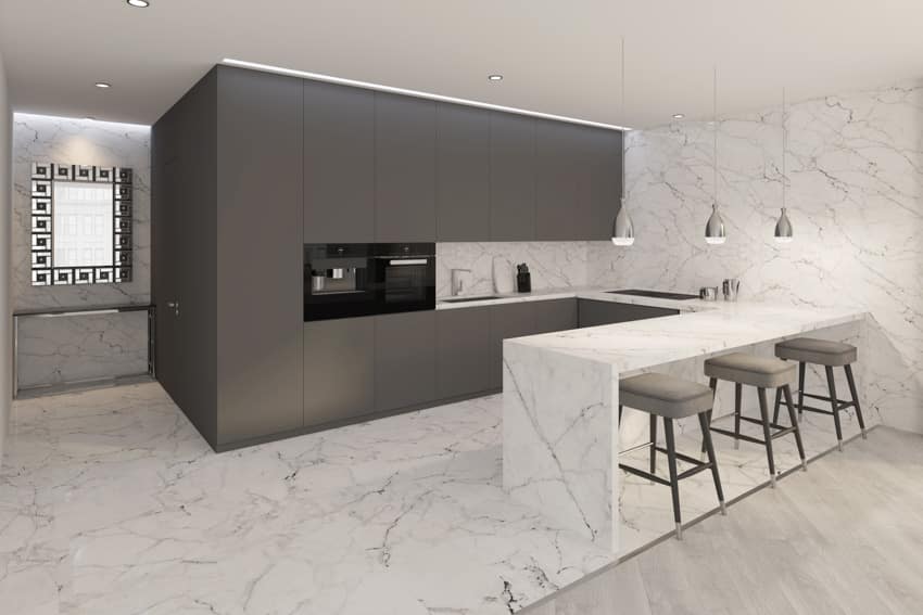 Modern kitchen with Statuario marble countertop, floor, black cabinets, pendant lights, and backsplash