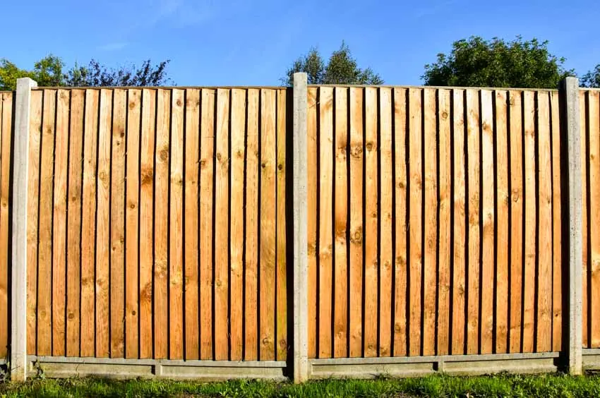 Overlapping fences made of wood with thin concrete pillars