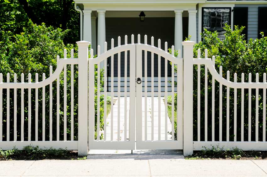 Residential property with fence, walkway, porch, and fence gate