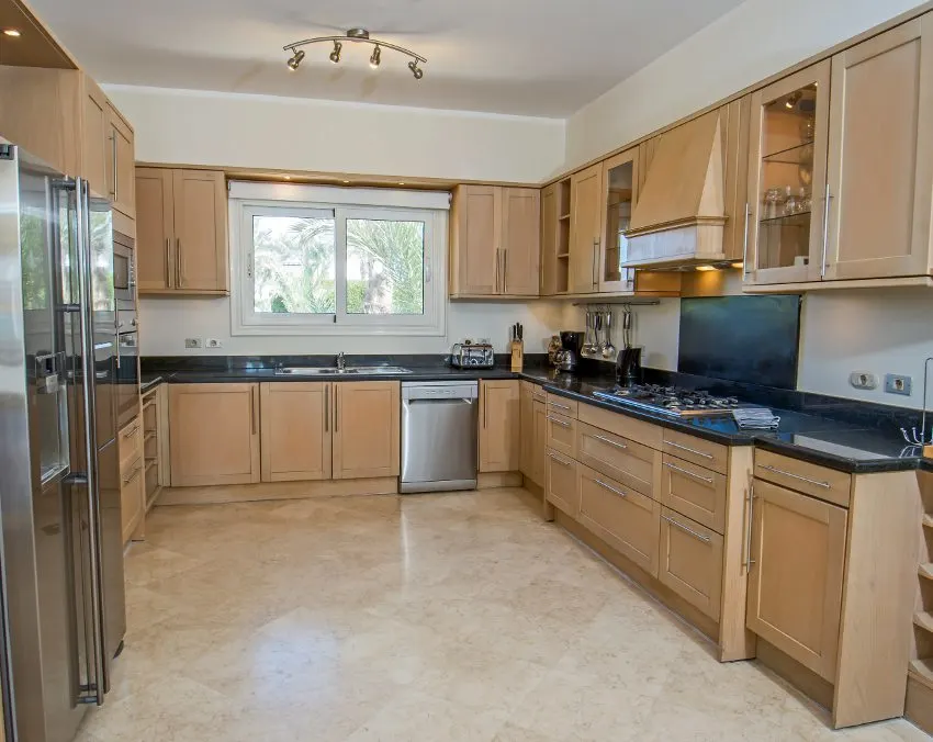 Spacious kitchen with tiled floors, and stainless steel appliances 