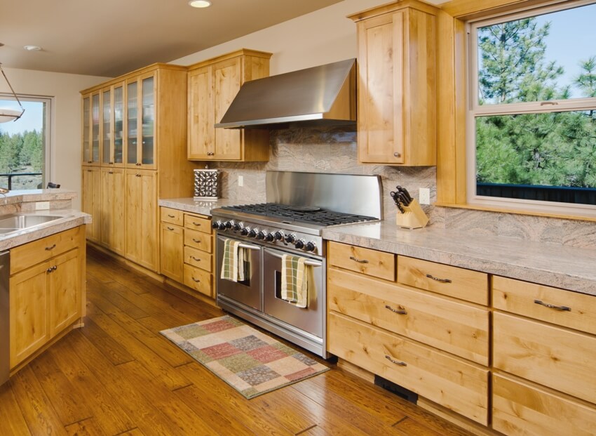 Kitchen with stove, hood and single hung windows