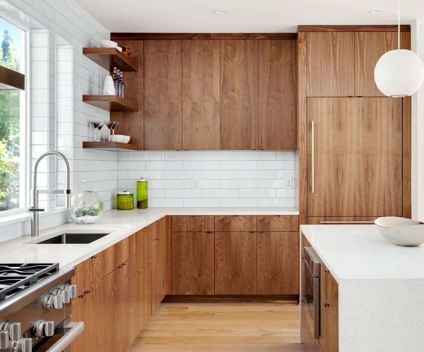 Stunning modern farmhouse kitchen with euro style cabinets, subway tile backsplash and wooden floors
