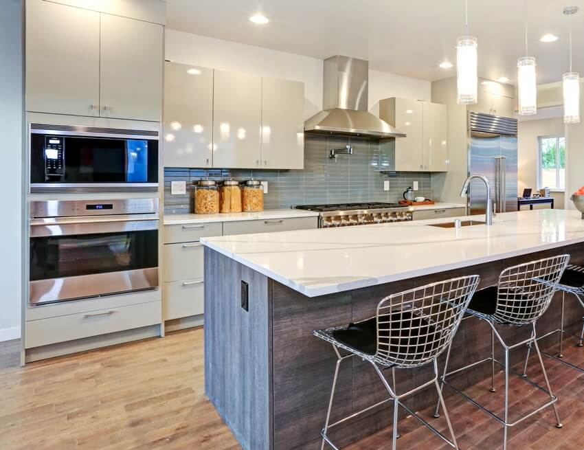 Kitchen with white glossy lacquer paint cabinet, wrought iron chairs and white cabinets