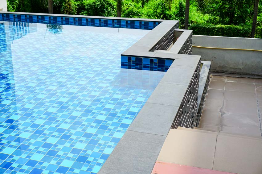 Swimming pool with glass tile finish, and tile deck