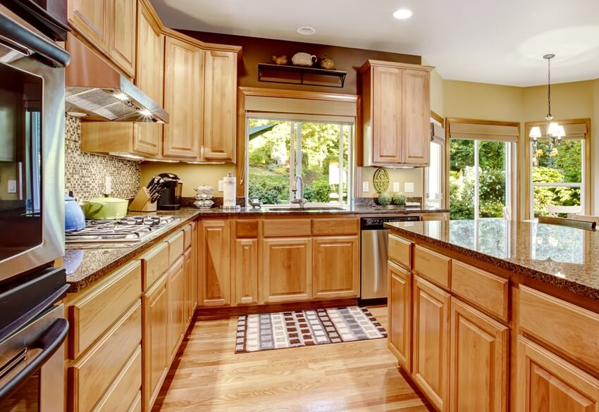 Kitchen with wooden floors, natural wood cabinets and kitchen island