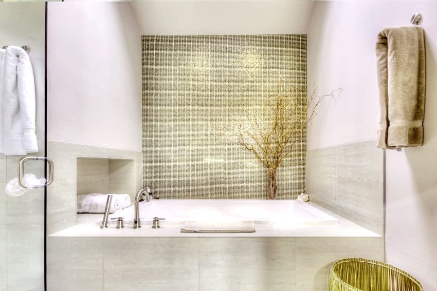 Gold metallic feature tiles above tub