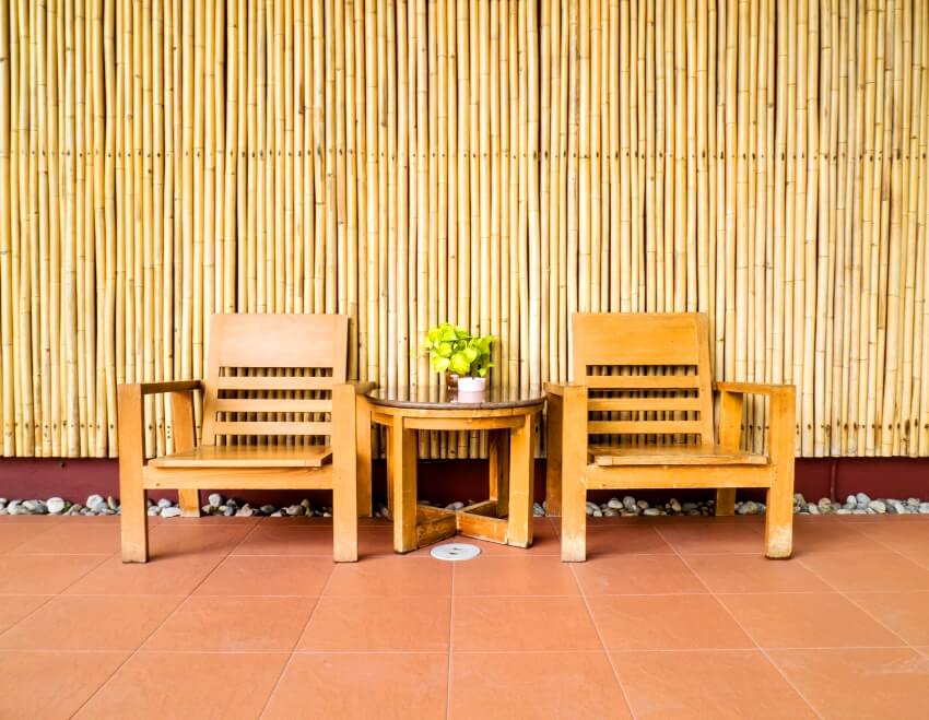 Wooden chair old style in front of the bamboo wall panel