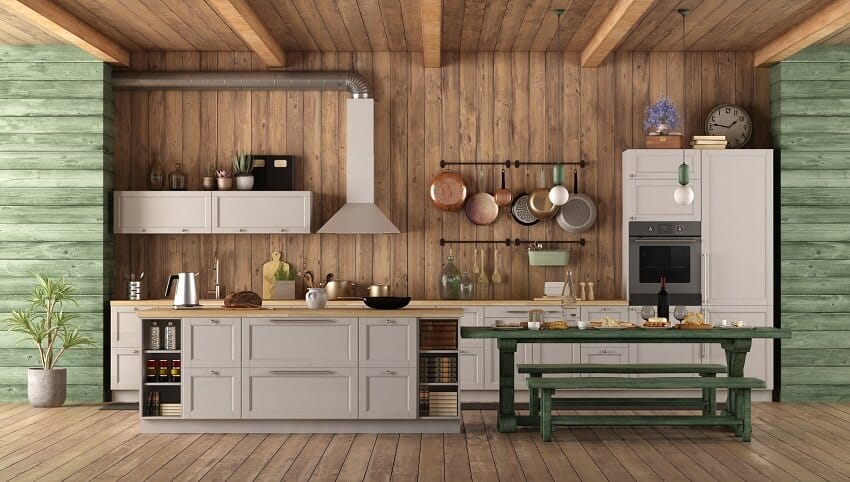 Wooden kitchen interior with white cabinets, green accents, island and kitchen cookware