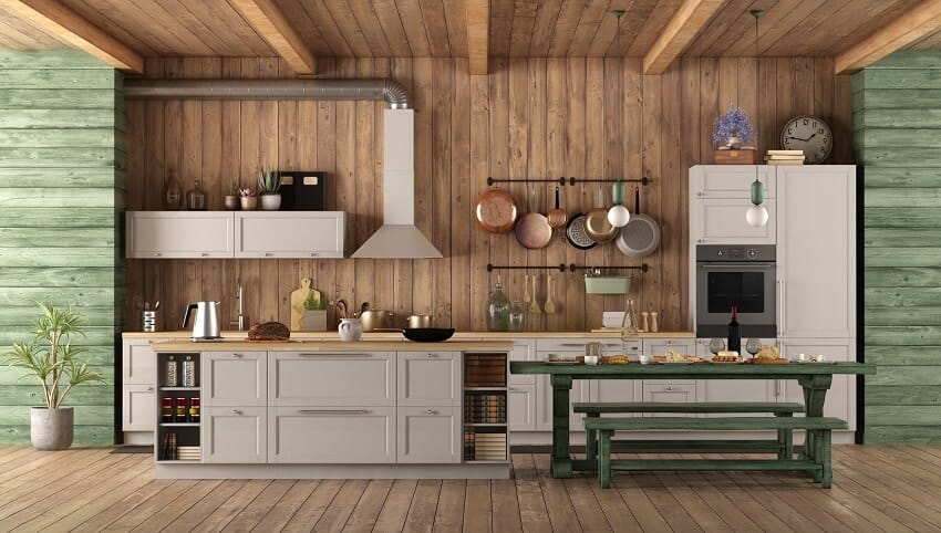 Kitchen with green siding, green table, and hanging pots 