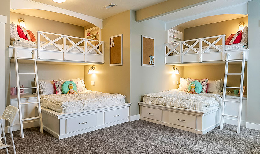 Big kids bedroom with built in bunk beds beige paint wall lamps floor carpet