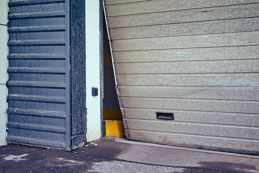 Damaged steel panel garage door