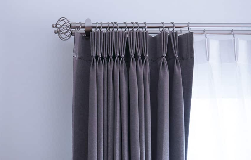 Gray curtain with stainless curtain rod three finger pinch pleat