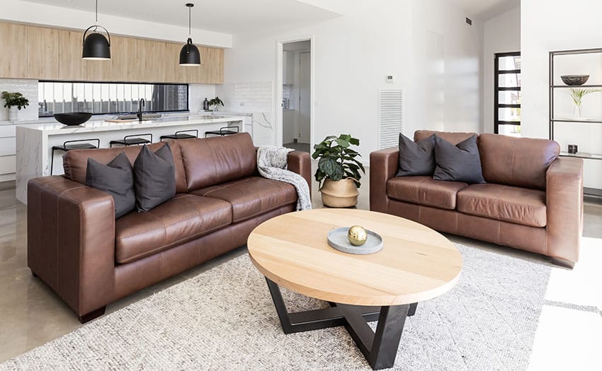 Living area with leather sofa coffee table rug