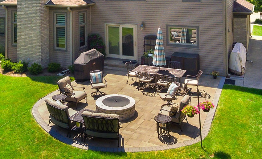Patio with patio table with umbrella couches fireplace