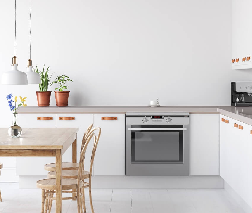 Scandinavian kitchen with white walls, hanging lamps and potted plants