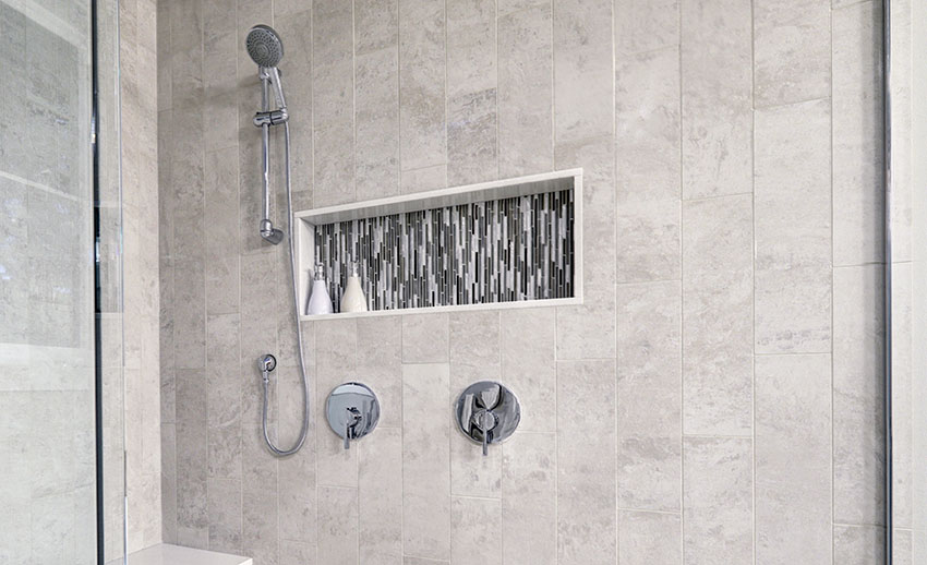 Bathroom with shower niche and vertically placed white tiles